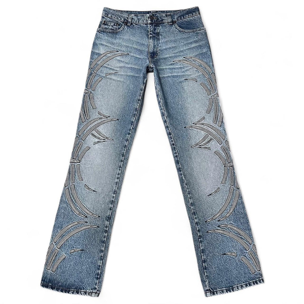 Curved tattoo embroidery blue jeans