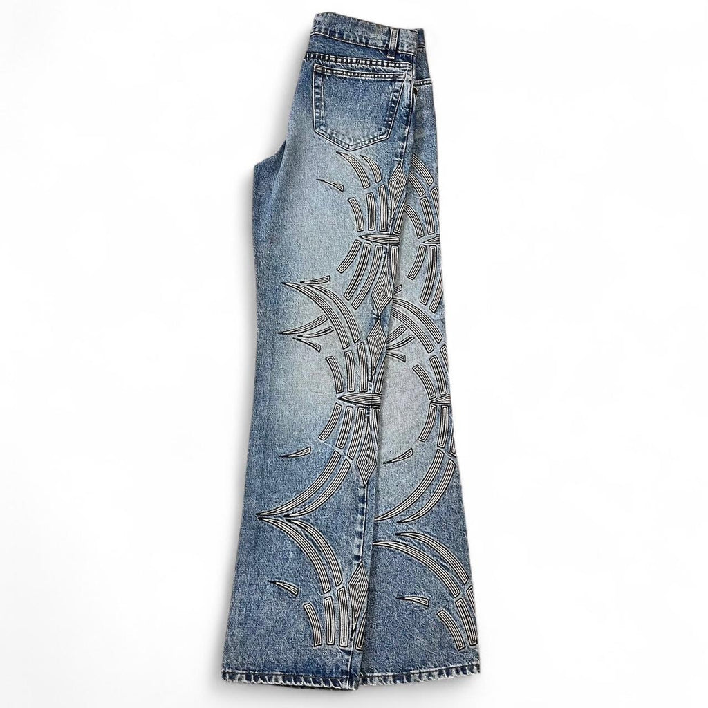 Curved tattoo embroidery blue jeans