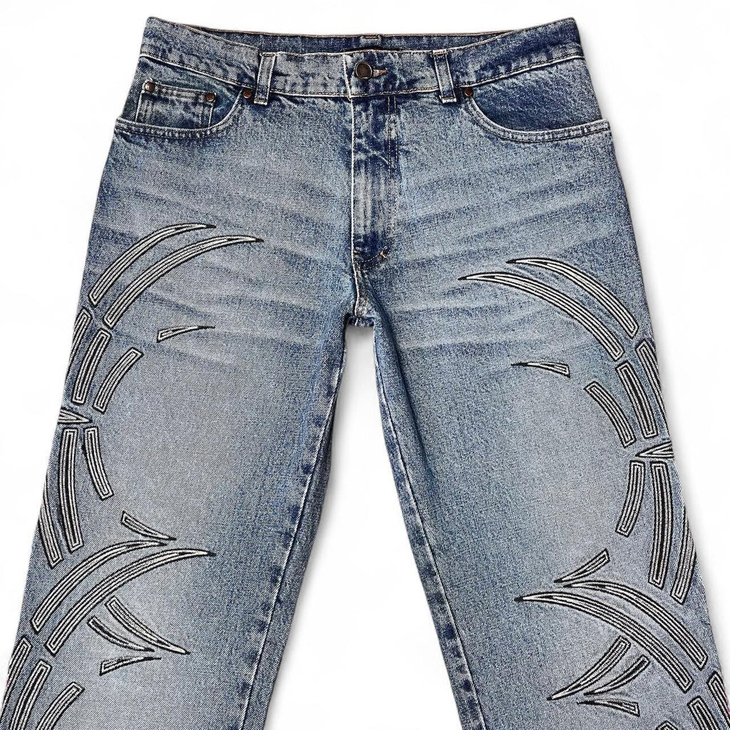Curved tattoo embroidery blue jeans