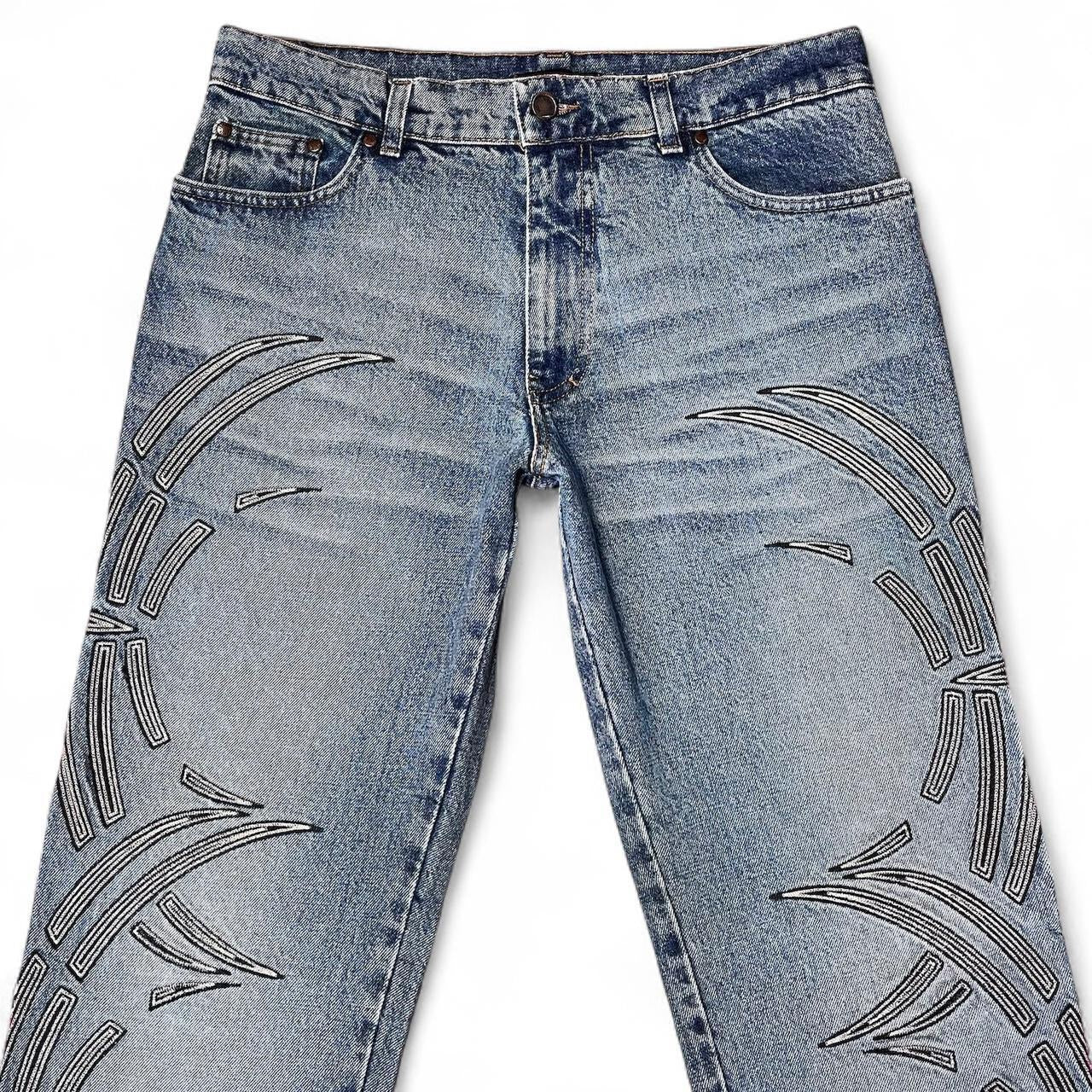 Curved tattoo embroidery blue jeans