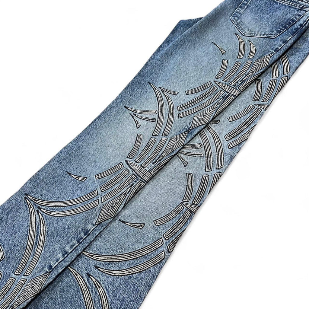 Curved tattoo embroidery blue jeans