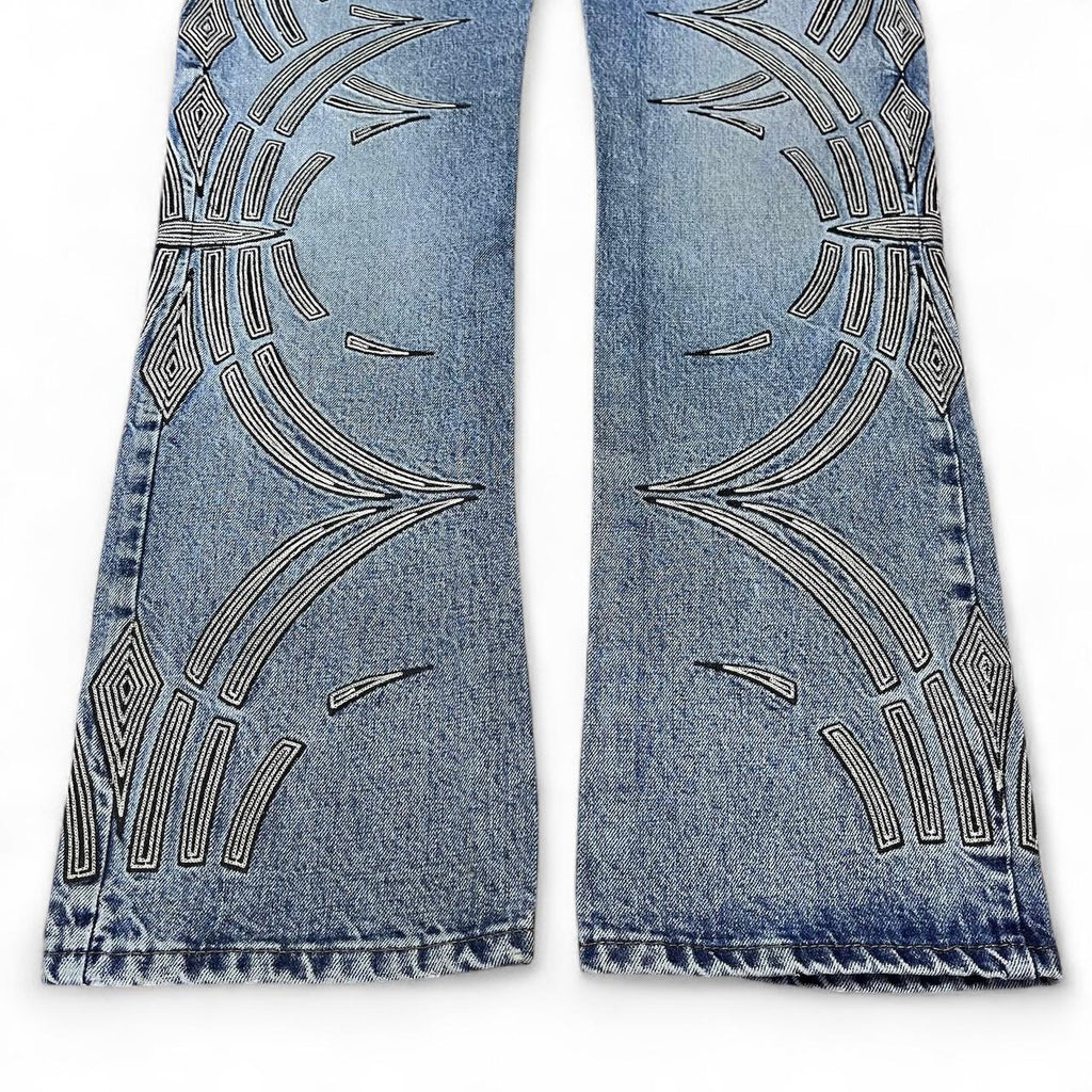 Curved tattoo embroidery blue jeans