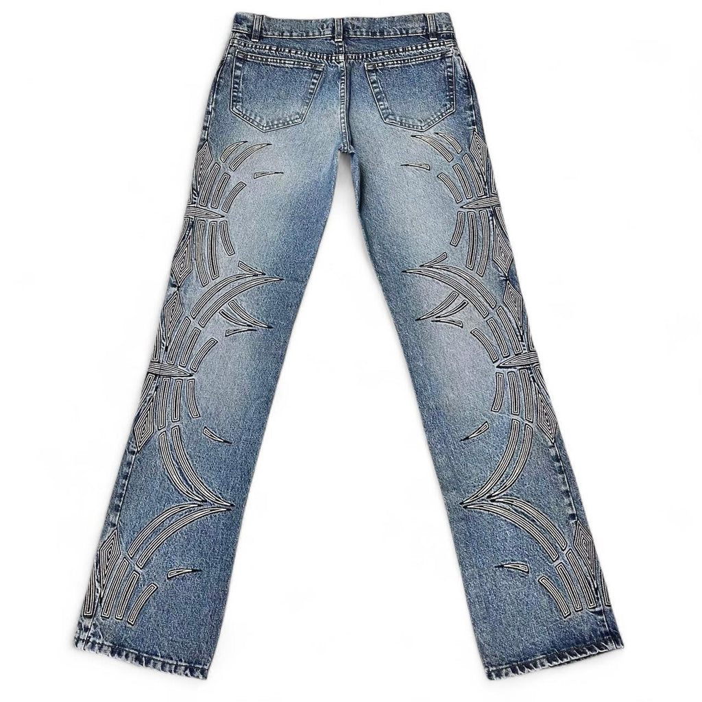Curved tattoo embroidery blue jeans